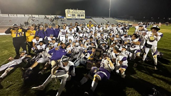 Lemoore's Division II champions gather on the field after winning the Division III football championship 62-46 over Central Valley Christian Friday night in Visalia.